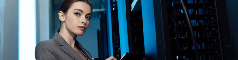 businesswoman taking notes on a clip board in a server room