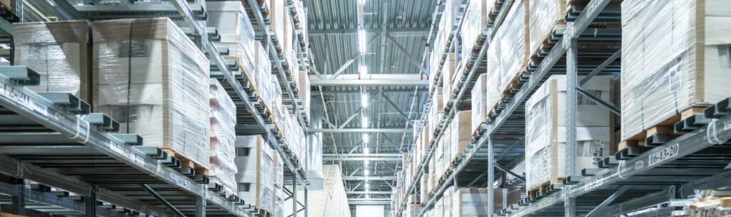 Rows Of Shelves With Boxes In Modern Warehouse